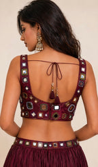 Elegant mirror work blouse in luxurious wine-maroon shade crafted for festive glamour and timeless ethnic style.