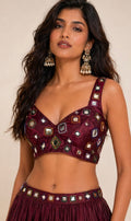 Elegant mirror work blouse in luxurious wine-maroon shade crafted for festive glamour and timeless ethnic style.